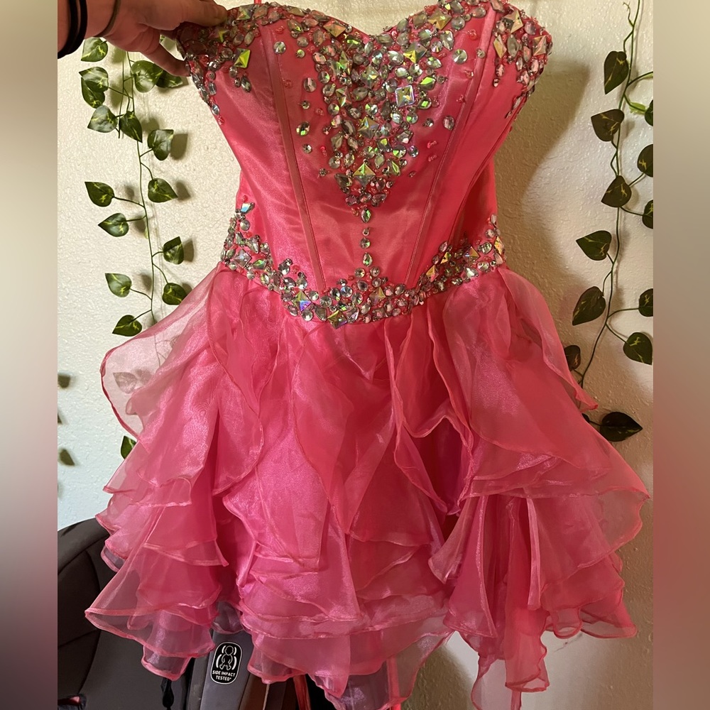 Strapless pink rhinestone formal knee length dress with adjustable corset back.